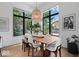 Dining space with modern table, chairs, and large windows offering ample natural light and outdoor views at 855 N East N St # 104-B, Indianapolis, IN 46202