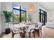 Bright dining area with large windows, stylish light fixture, and a view of the outdoor space at 855 N East N St # 104-B, Indianapolis, IN 46202