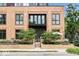 The building's exterior features brick facade, a gated entrance, and landscaping at 855 N East N St # 104-B, Indianapolis, IN 46202
