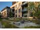 Modern apartment building with balconies, courtyard with benches, and landscaping at 855 N East N St # 104-B, Indianapolis, IN 46202