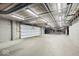 A well-lit and spacious parking garage inside the building with clearly marked lanes and designated parking spots at 855 N East N St # 104-B, Indianapolis, IN 46202