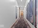 Hallway with wood floors, accent carpet, recessed lighting, and framed prints at 855 N East N St # 104-B, Indianapolis, IN 46202