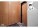 Hallway with wood panel walls, a door to an apartment, and unit number 104 at 855 N East N St # 104-B, Indianapolis, IN 46202