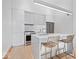 Contemporary kitchen featuring sleek white cabinetry and marble island at 855 N East N St # 104-B, Indianapolis, IN 46202