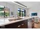 Kitchen island with a large sink, stainless steel appliances, and pendant lighting in an open layout at 855 N East N St # 104-B, Indianapolis, IN 46202