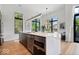 Kitchen area with a large island with seating, stainless steel appliances, and modern lighting at 855 N East N St # 104-B, Indianapolis, IN 46202