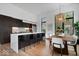 Modern kitchen with a waterfall island, stainless steel appliances, and an adjacent dining area with bright windows at 855 N East N St # 104-B, Indianapolis, IN 46202