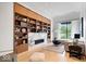 Cozy living room with built in shelving, fireplace and a view of the outdoors at 855 N East N St # 104-B, Indianapolis, IN 46202