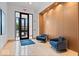 Comfortable lobby area with blue armchairs and a welcome mat in a luxury building at 855 N East N St # 104-B, Indianapolis, IN 46202