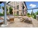 Inviting outdoor area featuring seating, fire pit, dining table, and stainless steel grill at 855 N East N St # 104-B, Indianapolis, IN 46202
