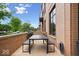 Outdoor dining area with a table, benches, and a grill, perfect for entertaining at 855 N East N St # 104-B, Indianapolis, IN 46202