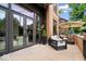 Inviting outdoor patio with modern furniture and planters, adjacent to large glass doors at 855 N East N St # 104-B, Indianapolis, IN 46202