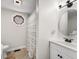 Cozy bathroom featuring a unique octagon window, shower with white and gray striped curtain, and a white vanity at 8576 Riser Dr, , IN 46164