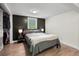 Cozy bedroom featuring a queen bed with grey bedding, modern lamps, and a large window at 8576 Riser Dr, , IN 46164