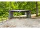 View of the carport with a gravel driveway, a secondary storage shed, and a fenced yard at 8576 Riser Dr, , IN 46164