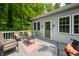 Relaxing outdoor deck features stylish seating and wooded views at 8576 Riser Dr, , IN 46164