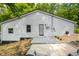 Rear exterior view highlighting the light gray siding, black trim windows and door, creating a clean and inviting aesthetic at 8576 Riser Dr, , IN 46164