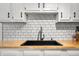 Bright kitchen features white cabinets, butcher block countertops, undermount sink and subway tile backsplash at 8576 Riser Dr, , IN 46164