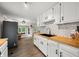 Open kitchen features white cabinets, butcher block countertops, stainless steel appliances, and wood flooring at 8576 Riser Dr, , IN 46164