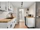 Bright kitchen features white cabinets, butcher block countertops, subway tile backsplash, and stainless steel appliances at 8576 Riser Dr, , IN 46164