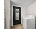 A laundry room features a washer, dryer, built-in shelving and a unique octagon mirror on the back of a black door at 8576 Riser Dr, , IN 46164
