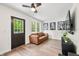 Bright living room features hardwood floors, a comfy sofa, and natural light through the windows and door at 8576 Riser Dr, , IN 46164