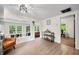 Open living area with wood floors, stylish furniture, and a view into the adjacent dining area at 8576 Riser Dr, , IN 46164