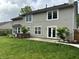 Exterior rear view features a lush, green lawn and patio with a personal hot tub spa at 8926 Durban Ct, Indianapolis, IN 46234