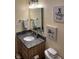This cozy bathroom features granite countertops, decorative lighting, and charming pig-themed artwork at 8926 Durban Ct, Indianapolis, IN 46234