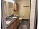 This bathroom boasts double sinks with granite countertops and plenty of storage in the wooden cabinets at 8926 Durban Ct, Indianapolis, IN 46234