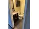 Cozy half bathroom featuring a pedestal sink with granite countertop and decorative mosaic backsplash at 8926 Durban Ct, Indianapolis, IN 46234