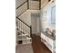 Inviting foyer features staircase with white railing, wood floors, and neutral decor at 8926 Durban Ct, Indianapolis, IN 46234