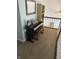 This cozy hallway landing features a piano and a bookshelf, creating a unique and inviting space at 8926 Durban Ct, Indianapolis, IN 46234