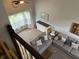 This spacious living room features a gray sofa and large windows with sheer curtains, providing ample natural light at 8926 Durban Ct, Indianapolis, IN 46234
