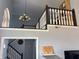 Second-floor loft overlooking the home's entrance, featuring a chandelier and dark wood railing at 8926 Durban Ct, Indianapolis, IN 46234