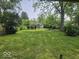 Expansive backyard with lush green lawn and mature trees, offering a serene outdoor space at 927 Cecil Ave, Indianapolis, IN 46219