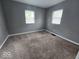 Bedroom with new carpeting, neutral paint, and bright windows at 927 Cecil Ave, Indianapolis, IN 46219