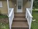 Welcome home with this charming entryway porch with stairs and white railings at 927 Cecil Ave, Indianapolis, IN 46219