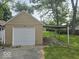 View of detached garage with carport in backyard at 927 Cecil Ave, Indianapolis, IN 46219