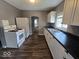 Efficient kitchen with white cabinets, black countertops, and modern appliances at 927 Cecil Ave, Indianapolis, IN 46219