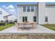 Inviting backyard patio featuring a modern outdoor dining set at 9949 Nightsong Ln, Avon, IN 46123