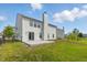 Large backyard with a concrete patio, lush lawn, and black chain-link fence at 9949 Nightsong Ln, Avon, IN 46123