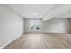 Bright, open basement with wood-look flooring and two windows providing natural light at 9949 Nightsong Ln, Avon, IN 46123