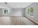 Spacious basement area with wood-look flooring, white trim, and natural light from the window at 9949 Nightsong Ln, Avon, IN 46123