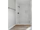 Modern tiled shower with a built-in shelf and sleek hardware in a bright bathroom at 9949 Nightsong Ln, Avon, IN 46123