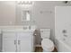 Bathroom with white cabinets, mirror, toilet and a shower/tub combo at 9949 Nightsong Ln, Avon, IN 46123