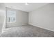 Bright bedroom featuring neutral walls, plush carpeting, and a sunny window at 9949 Nightsong Ln, Avon, IN 46123
