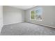 Carpeted bedroom with neutral walls and a large window offering scenic views at 9949 Nightsong Ln, Avon, IN 46123