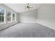 Large bedroom with neutral colors, a ceiling fan, and bright natural light from a window at 9949 Nightsong Ln, Avon, IN 46123