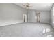 Neutral bedroom with a ceiling fan, plush carpet, and natural light from a window at 9949 Nightsong Ln, Avon, IN 46123